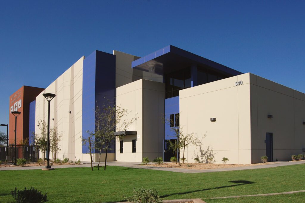 Modern Silvestre Herrera Elementary School with geometric design and clear blue sky.