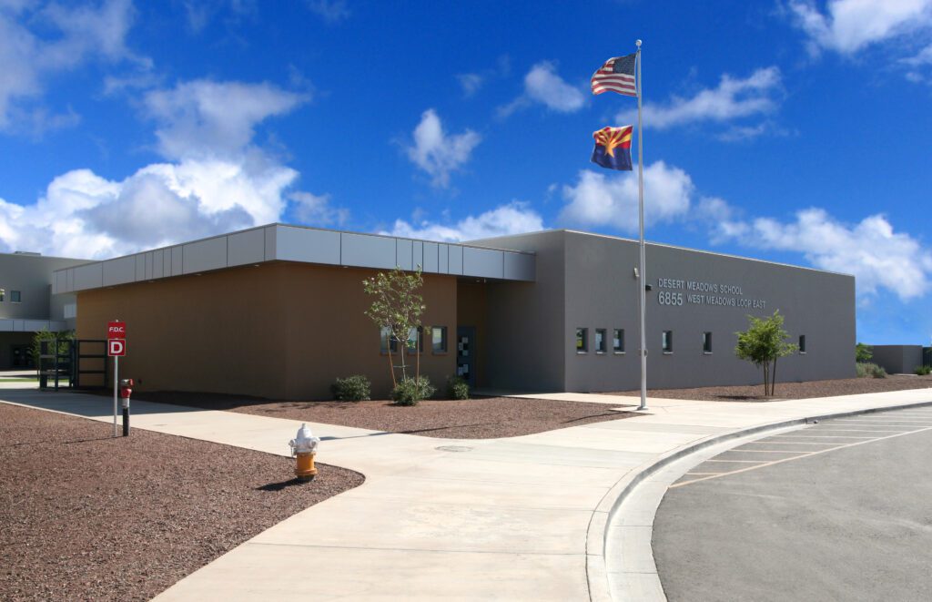 Four Peaks Elementary School's new campus features a modern building with American and Arizona state flags fluttering in the breeze.